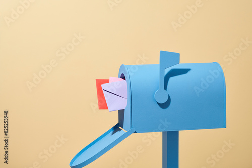 Incoming mail. mailbox with letter isolated on beige background photo
