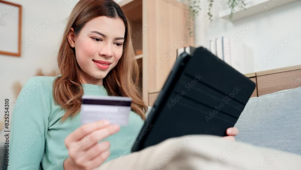 A woman express on her face with cheerful, conveying a sense of satisfaction and happiness with her online shopping and successful credit card transactions. A woman express on her face with cheerful, conveying a sense of satisfaction and happiness with her online shopping and successful credit card transactions.