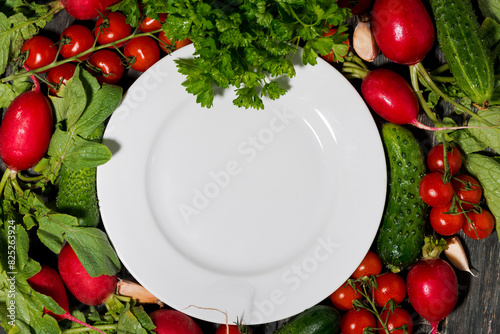 plate, background for text with fresh seasonal vegetables, top view