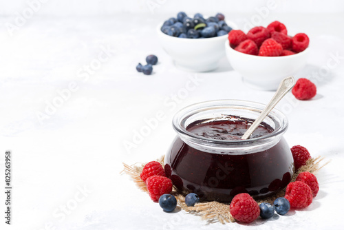 raspberry and blueberry jam in a glass jar