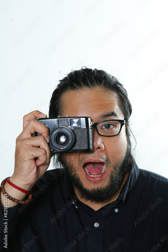 a photographer poses to shoot an object through a view finder using a pocket camera a photographer poses to shoot an object through a view finder using a pocket camera