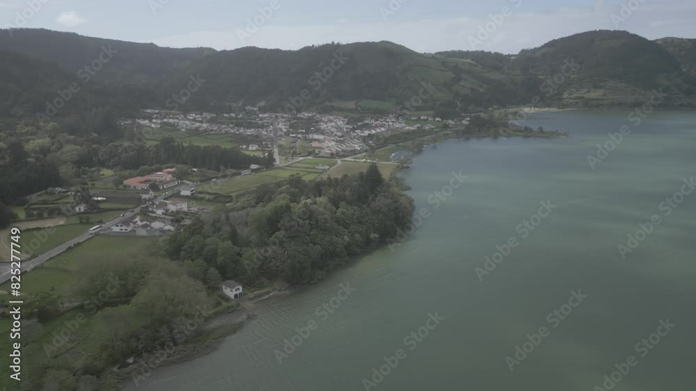 Scenic aerial view of Sete Cidades village by the lakes in Portugal surrounded by lush green hills Scenic aerial view of Sete Cidades village by the lakes in Portugal surrounded by lush green hills