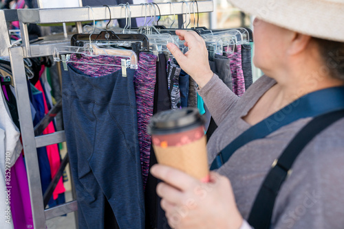 Woman shopping while holding to go cup photo