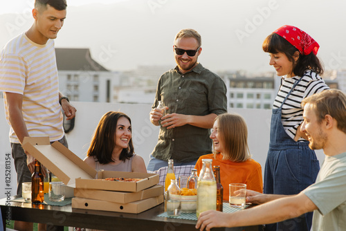 Friends having party on rooftop with drinks photo