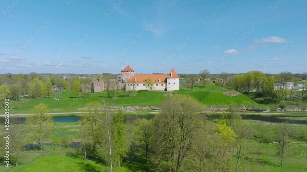 Aerial establishing view of Bauska Medieval Castle and ruins, Musa and Memele rivers next to the castle, sunny spring day, wide drone shot moving forward Aerial establishing view of Bauska Medieval Castle and ruins, Musa and Memele rivers next to the castle, sunny spring day, wide drone shot moving forward