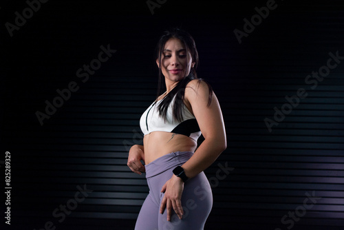 portrait of a female athlete in sportswear posing for the camera wearing a smart watch
