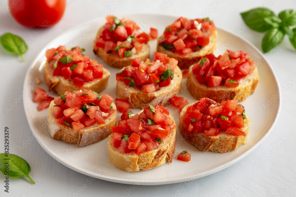 Homemade Bruschetta with Basil and Tomatoes on a Plate, side view. Homemade Bruschetta with Basil and Tomatoes on a Plate, side view.