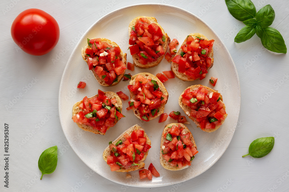 Homemade Bruschetta with Basil and Tomatoes on a Plate, top view. Homemade Bruschetta with Basil and Tomatoes on a Plate, top view.