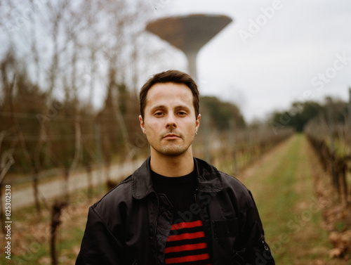 Man Standing in Vineyard at Dusk photo
