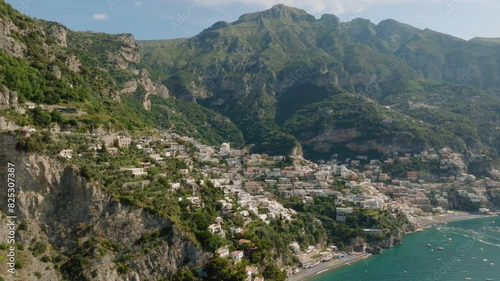 Aerial: Slow panning panoramic drone shot of Positano in Amalfi coast on a sunny day Aerial: Slow panning panoramic drone shot of Positano in Amalfi coast on a sunny day
