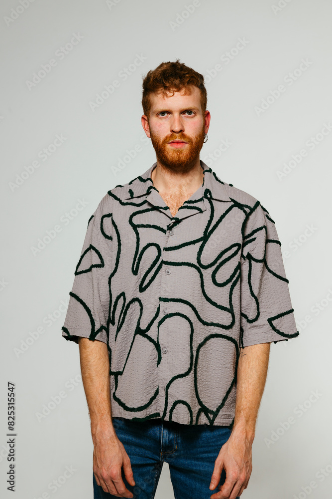 Serious man in modern clothes looking at camera in studio Serious man in modern clothes looking at camera in studio