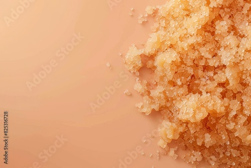 The image features a close-up of a brown sugar scrub product on a solid beige or soft peach background,showcasing a minimalist and simple advertisement for a natural,organic,and luxurious beauty or photo