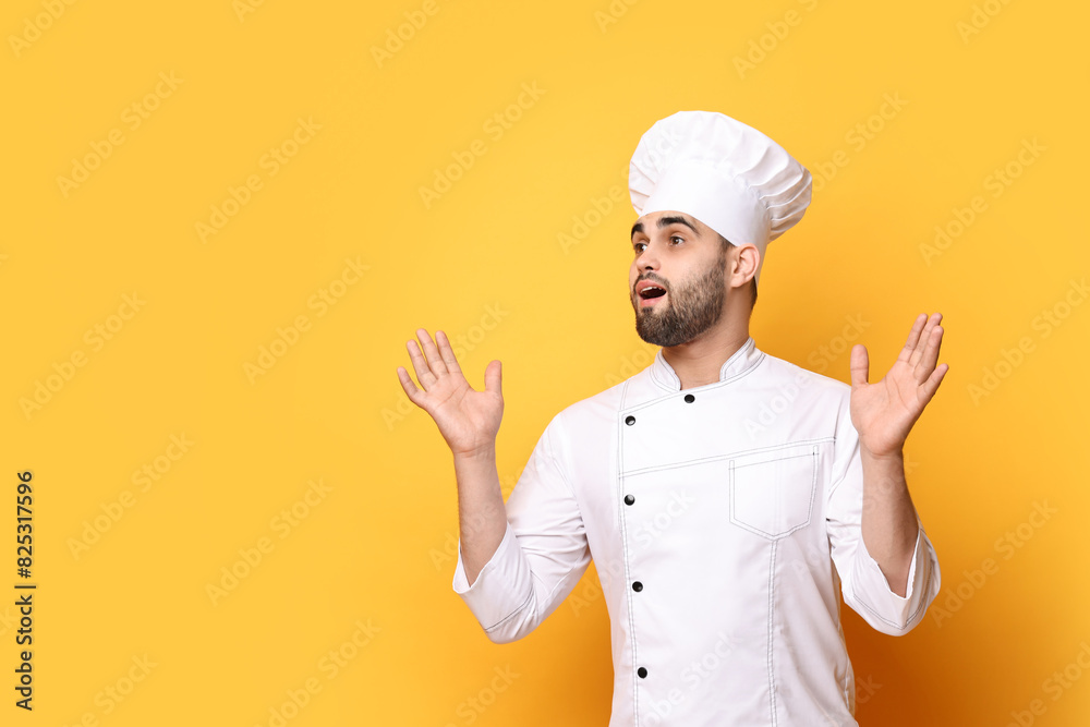 Surprised chef in uniform on yellow background. Space for text Surprised chef in uniform on yellow background. Space for text
