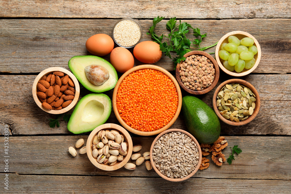 Different products high in natural fats on wooden table, flat lay Different products high in natural fats on wooden table, flat lay