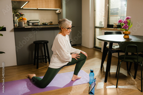 A woman does yoga at home photo