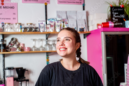 Coffee shop owner businesswoman standing behind the counter photo