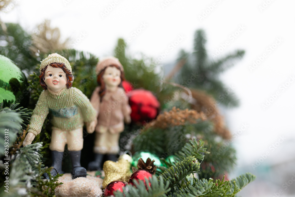 Couple of Figurines Sitting on Top of a Christmas Tree Couple of Figurines Sitting on Top of a Christmas Tree