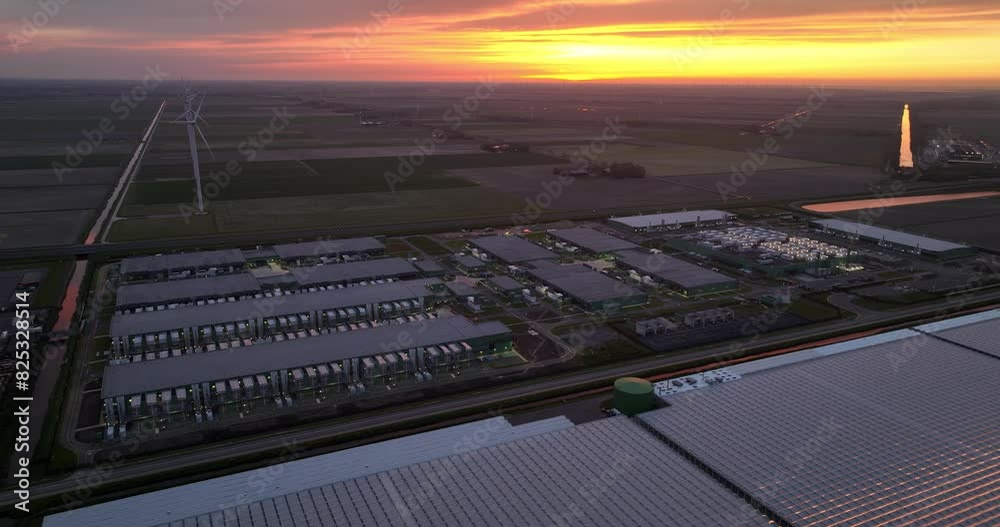Datacenter internet infrastructure in the Polder of the Netherlands at sunset, dusk. Aerial drone view.