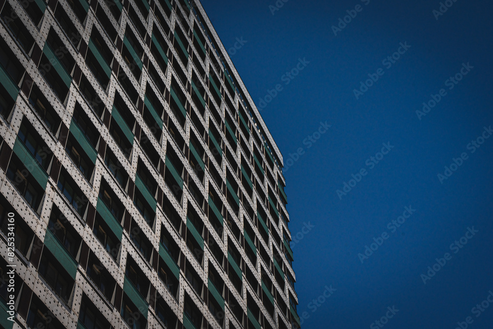 A multi-storey office building against a blue sky. Renting a property in a big city. A multi-storey office building against a blue sky. Renting a property in a big city.