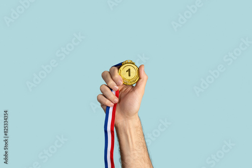 Person holding first prize gold medal. Success, competition, winner.