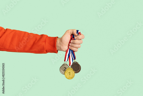 Person holding medals. Success, competition, winner, award.