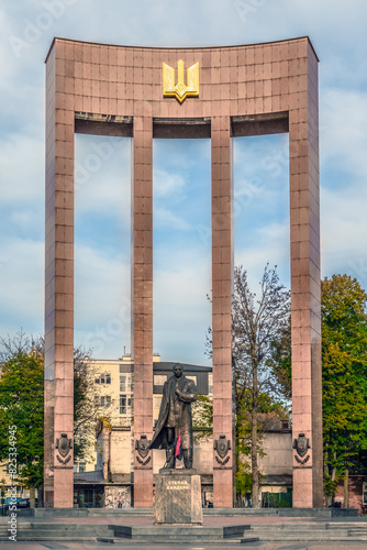 Lviv, Ukraine - November 2, 2023: Stepan Bandera monument by Mykola Posikira and Mykhailo Fedyk in Lviv, 2003. Male statue stands in front of the Stele of Ukrainian Statehood in the city square