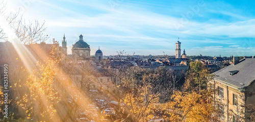 Spectacular Autumn Panorama of Lviv, Ukraine. City Bathed in Sunlight. View from High Castle Mountain. Widescreen Shot Capturing Urban Beauty photo