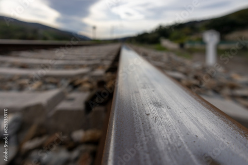 railroad track in foreground with out-of-focus background