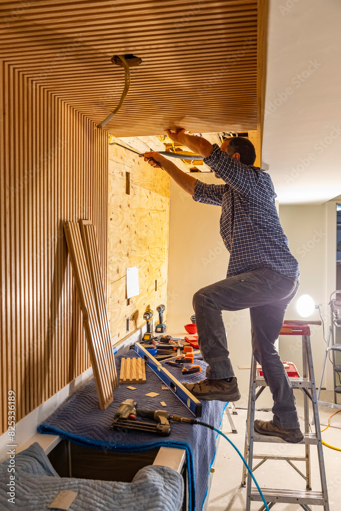 © Raymond Forbes LLC/Stocksy - Carpenter worker building Vertical wood paneling wall © Raymond Forbes LLC/Stocksy - Carpenter worker building Vertical wood paneling wall