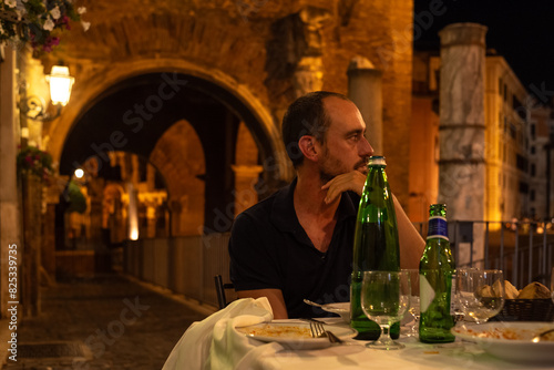 Man at table in Roman restaurant photo