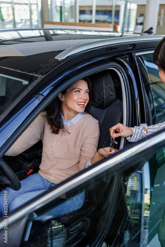 Woman getting the car keys for a test drive photo