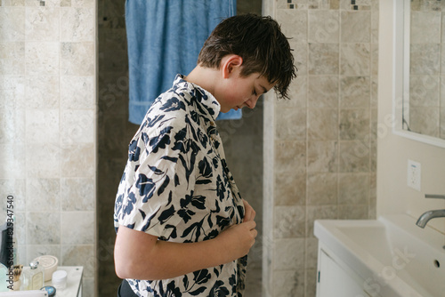 tween boy getting dressed in the morning 