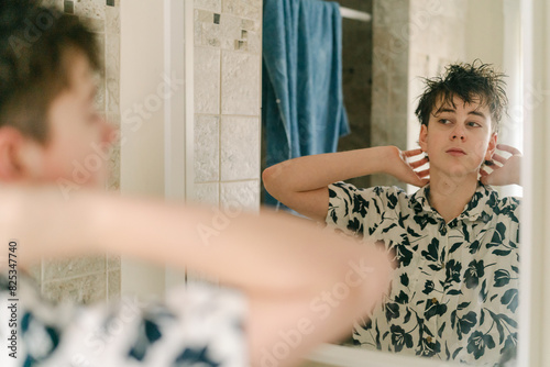 teen boy styling his hair photo