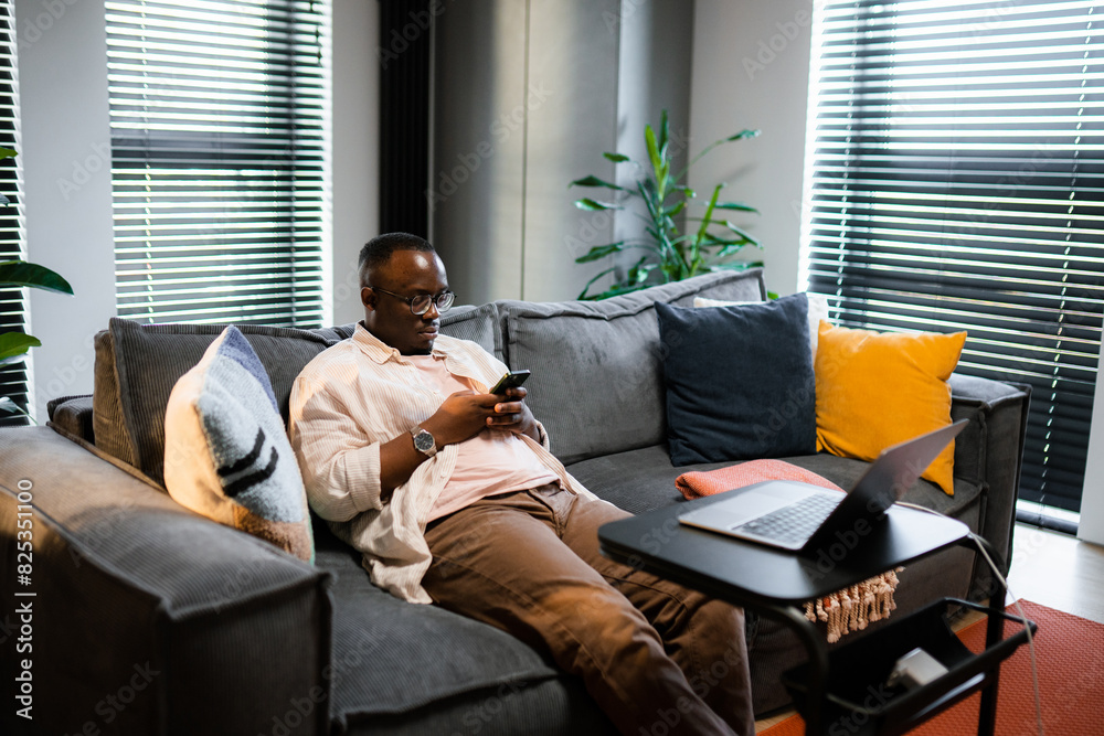 A man uses a mobile phone at home