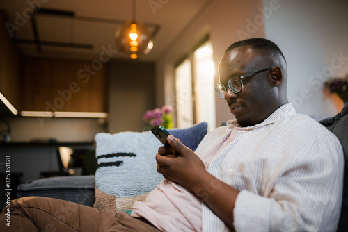 A man uses a mobile phone at home photo
