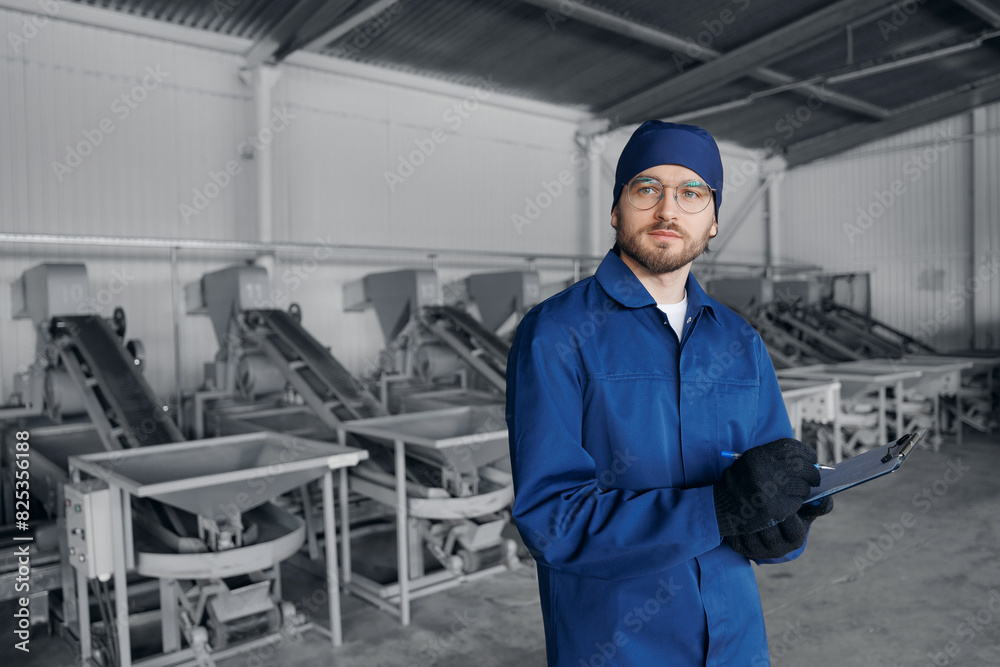 Worker man control quality product on automatic conveyor belt for transporting cedar nuts. Concept modern food industry, factory production line. Worker man control quality product on automatic conveyor belt for transporting cedar nuts. Concept modern food industry, factory production line.