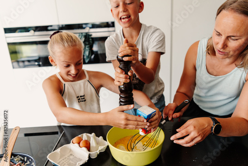 Happy family baking together in kitchen photo