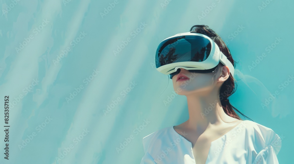 Exploring the metaverse, a woman with VR goggles is positioned against a light blue wall, representing the futuristic lifestyle made possible through cutting-edge technology