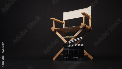 Director chair and Clapper board on black background.