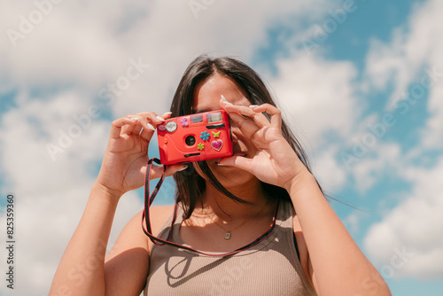 Teen taking an analog picture with a camera photo