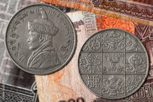 Closeup of Bhutan rupee coins with the portrait of king Jigme Dorji photo