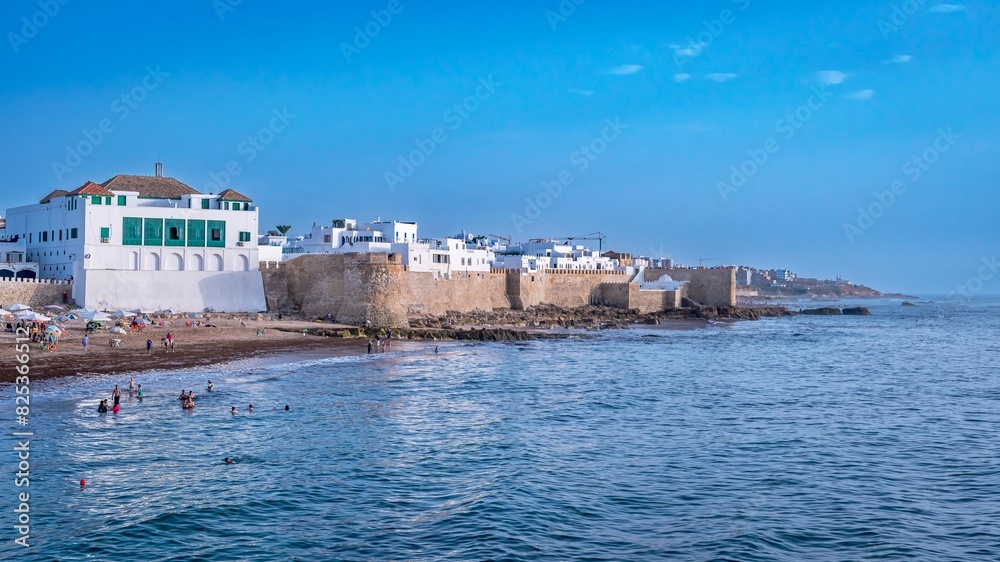 Scenic view of the coastline with white buildings at sunset