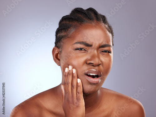 Portrait, toothache and black woman with pain, dental hygiene or oral health on grey studio background. African person, face or model with emergency, frustrated or cavity crisis with sensitive teeth