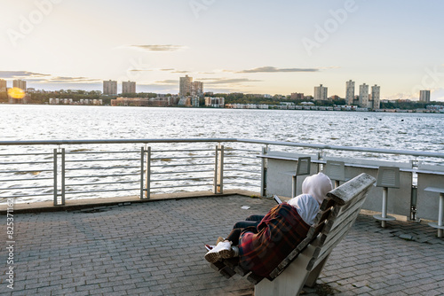 A couple relaxing at the Hudson River and wooden walkway at Hudson River park, New York