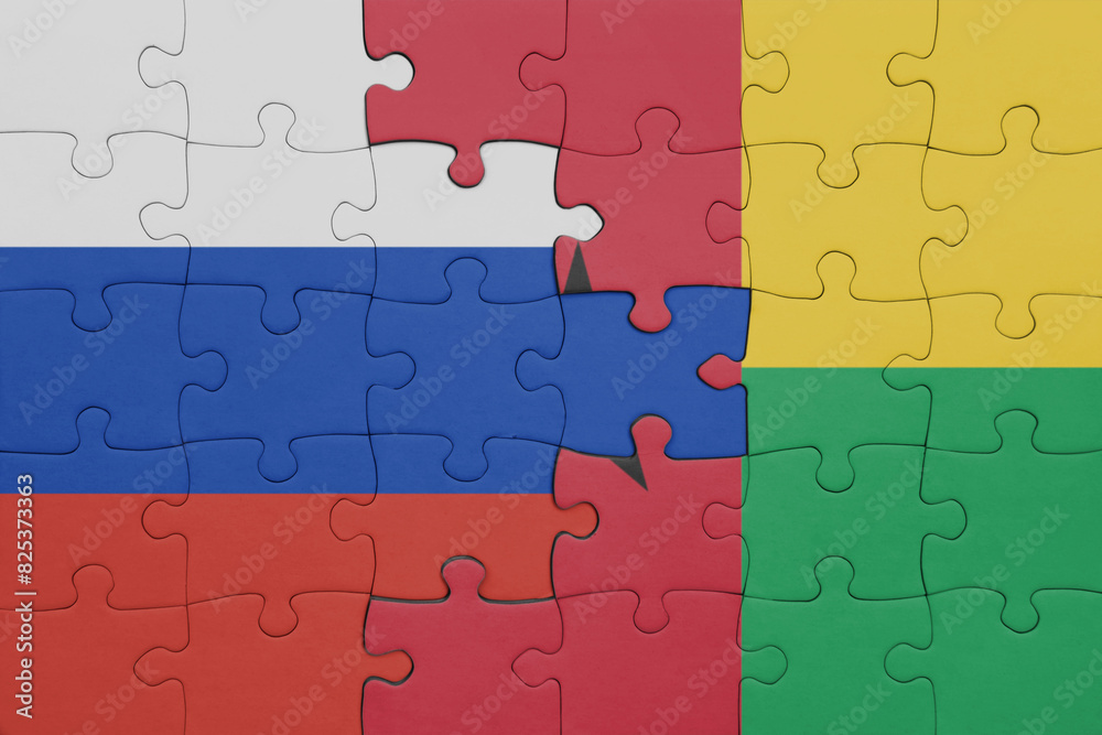 puzzle with the colourful national flag of guinea bissau and flag of russia. puzzle with the colourful national flag of guinea bissau and flag of russia.