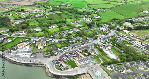 Ireland Epic locations drone flying over Ardmore Village seaside tourist attraction to Ardmore Round Tower on the hill overlooking the village in Waterford photo