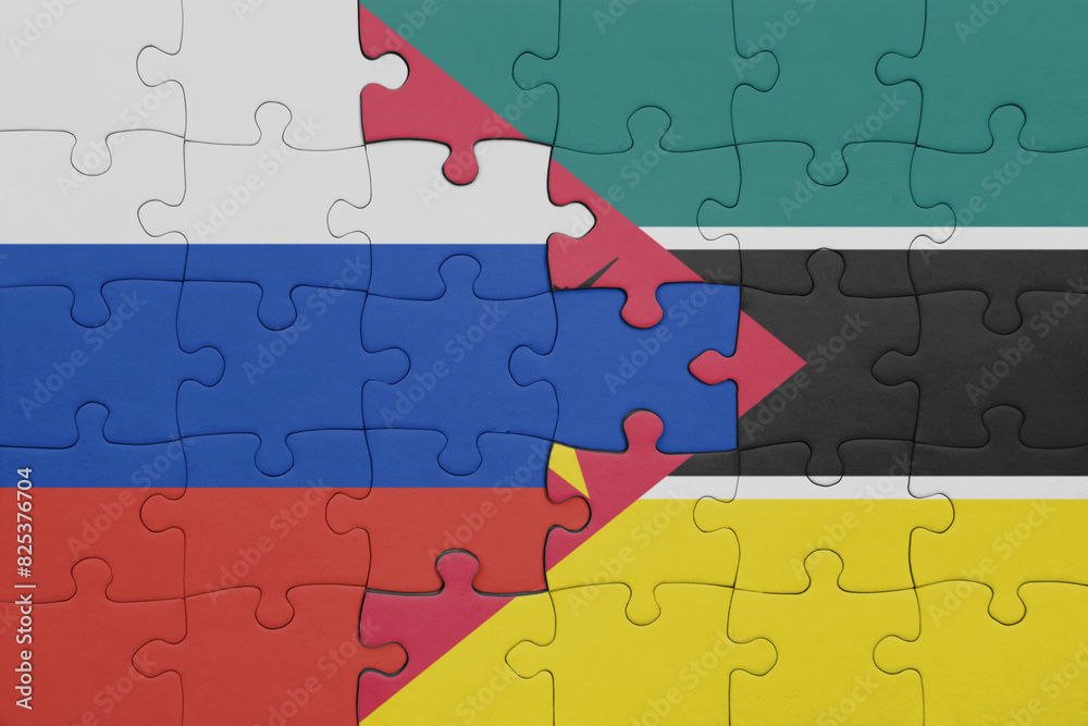 puzzle with the colourful national flag of mozambique and flag of russia. puzzle with the colourful national flag of mozambique and flag of russia.