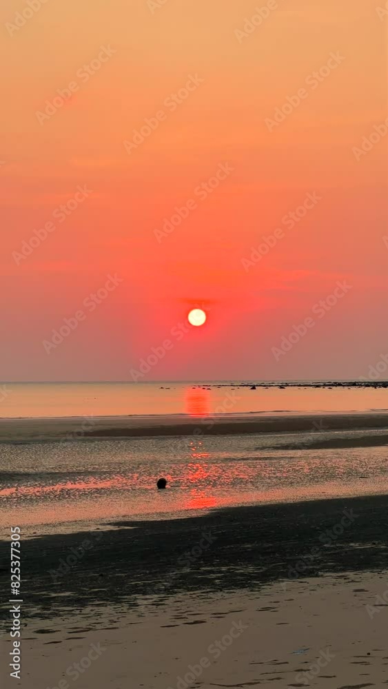 Serene beach landscape at sunset with vibrant orange skies reflecting on tranquil water. Peaceful nature scene for relaxation and background. Serene beach landscape at sunset with vibrant orange skies reflecting on tranquil water. Peaceful nature scene for relaxation and background.