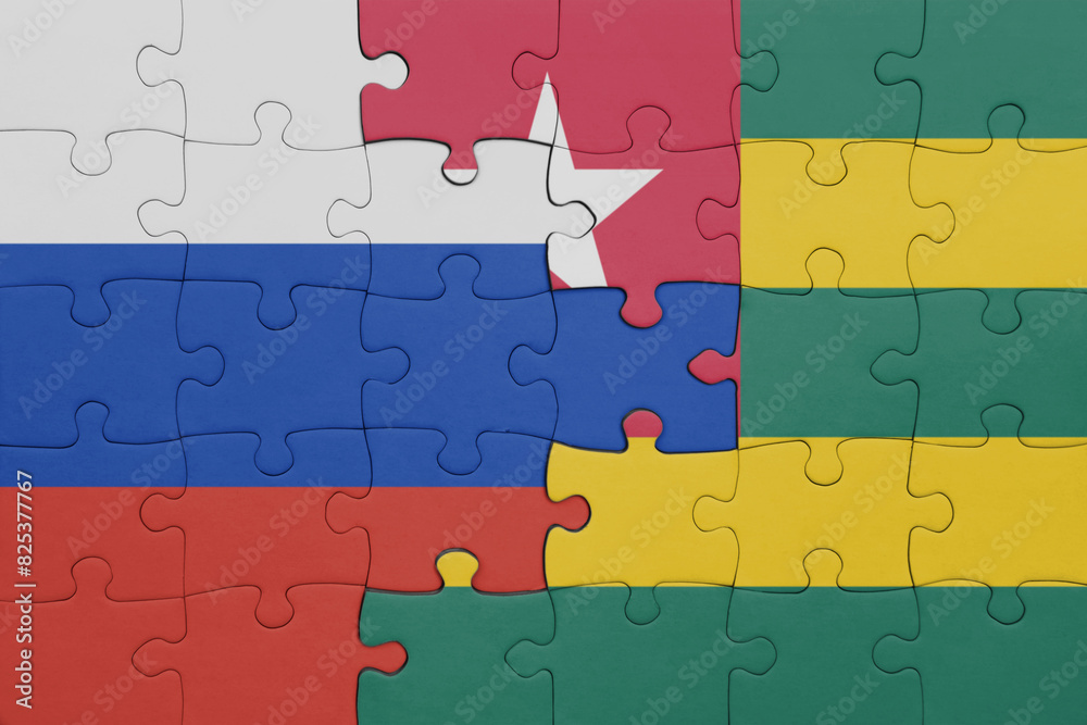 puzzle with the colourful national flag of togo and flag of russia. puzzle with the colourful national flag of togo and flag of russia.