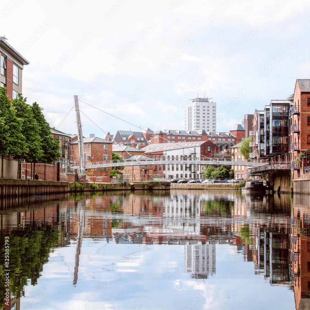 Fototapeta premium Urban landscape with skyscrapers, a bridge, and a waterfront